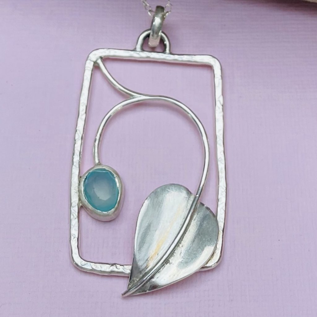 Sterling silver pendant with Chalcedony stone and heart motif.